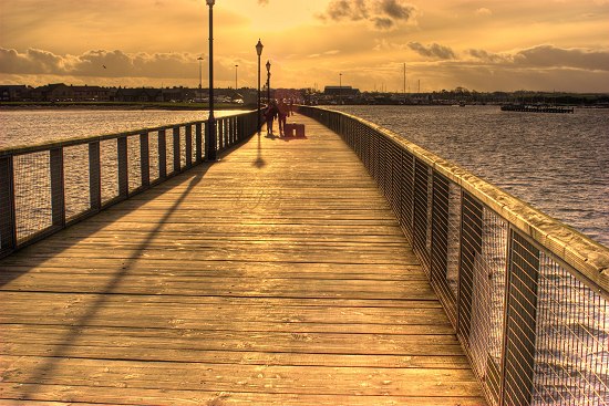 Sunset over the pier at Amble, Northumberland.