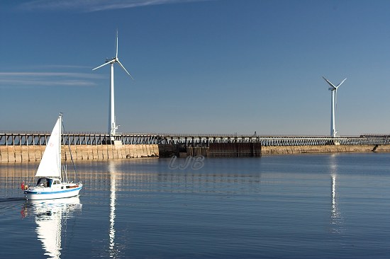Yacht leaving River Blyth, Northumberland.