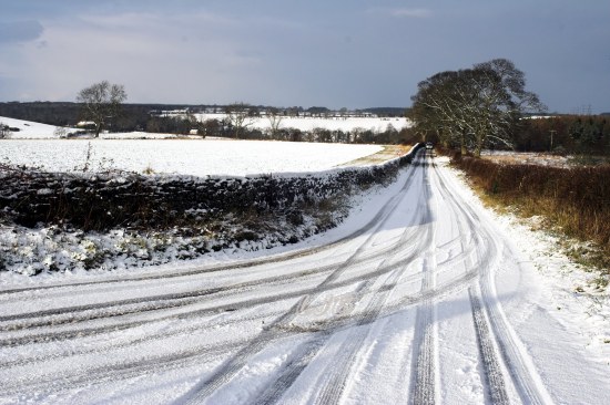 Snowbound road on a winter morning at Meldon, Northumberland.