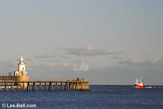 Fishing boat approaching Blyth West Pier, Northumberland.