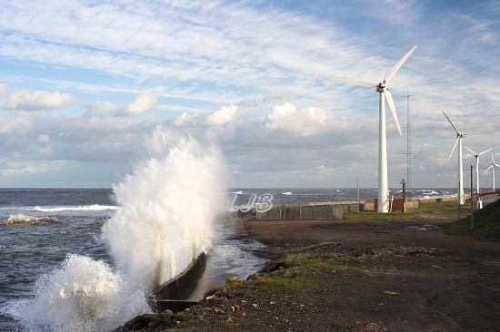 Waves blasting over the sea wall at North Blyth.