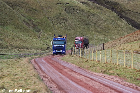 Timber trucks alongside the River Alwin, Cheviot Hills, Northumberland.