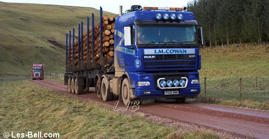 Timber trucks alongside the River Alwin, Cheviot Hills, Northumberland.