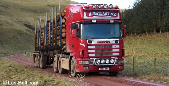 Timber trucks alongside the River Alwin, Cheviot Hills, Northumberland.