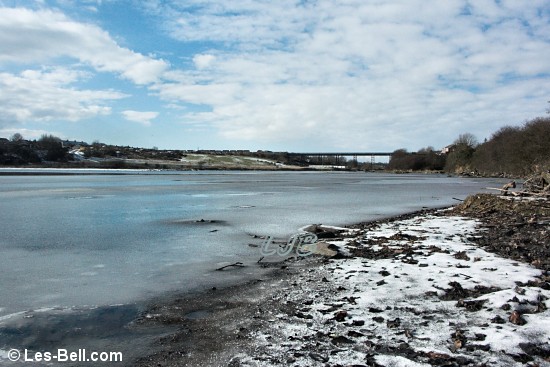 The frozen River Wansbeck looking towards the Black Bridge.