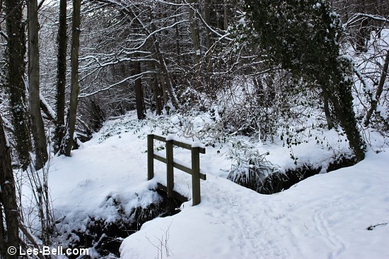 Snow covered footbridge on the path through the woods in the River Wansbeck valley between Bothal and Morpeth.