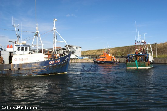 Eyemouth Lifeboat towing a fishing boat into the harbour.