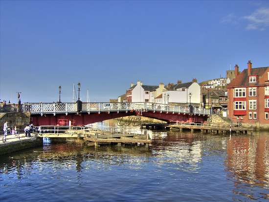 Whitby swing bridge opening for a yacht to pass through.