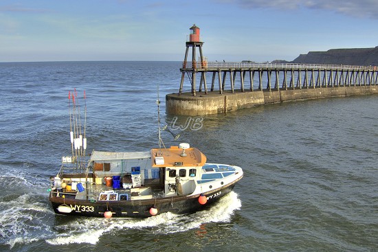 Fishing boats returning to Whitby.