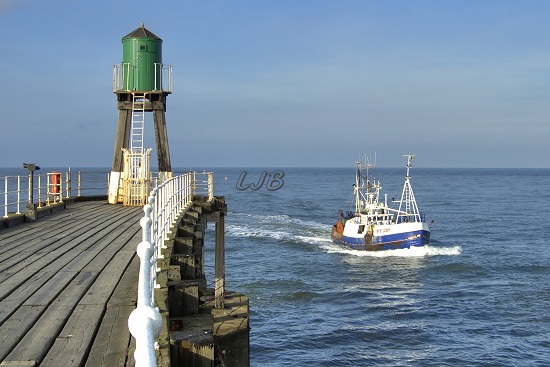 Fishing boats returning to Whitby.