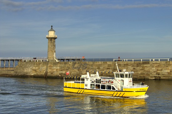 Cruise boat returning to Whitby.