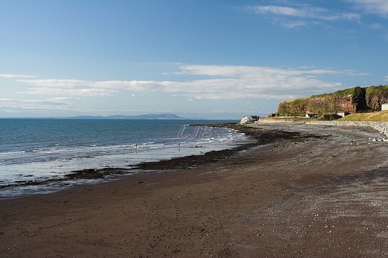 View along the beach to the north of the harbour.